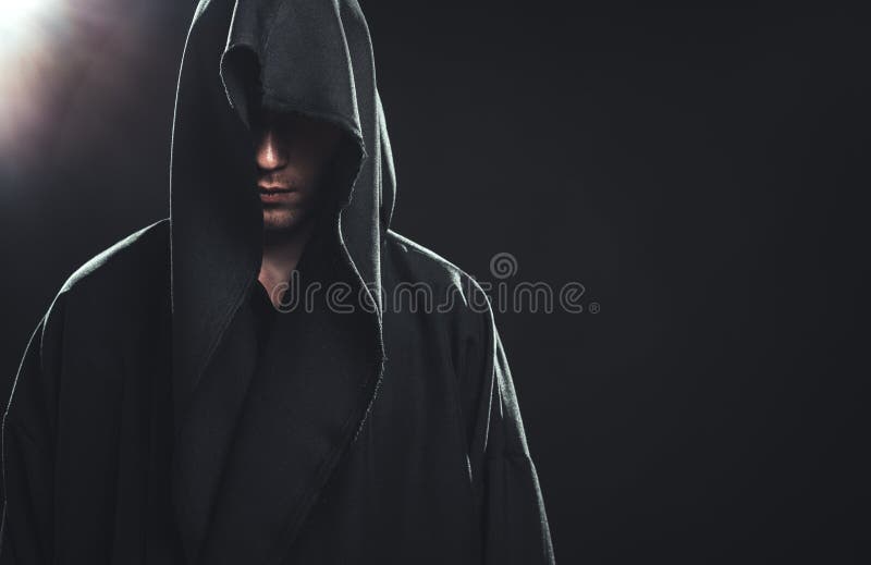 Portrait of a Man in a black robe on a dark background. Portrait of a Man in a black robe on a dark background