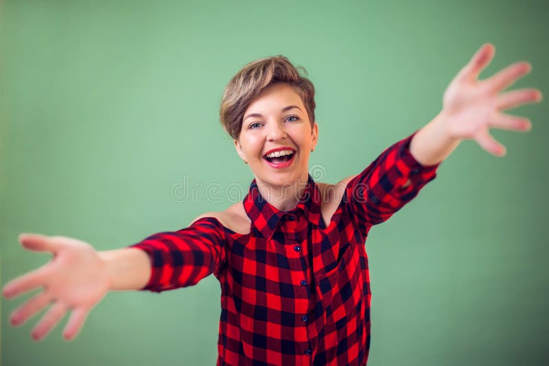 人们和情感-看照相机的愉快的妇女画象微笑与开放胳膊为拥抱 快乐表示拥抱. 人们和情感-看照相机的愉快的年轻女人画象微笑与开放胳膊为拥抱 接受幸福的快乐的表示