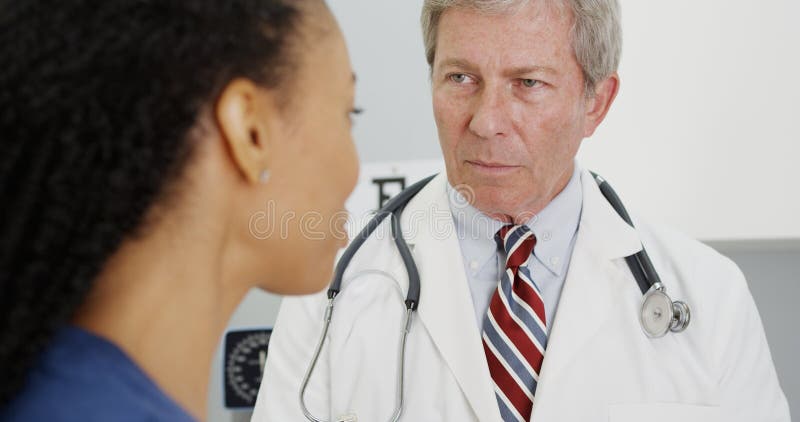 Black women patient talking to her doctor. Black women patient talking to her doctor.