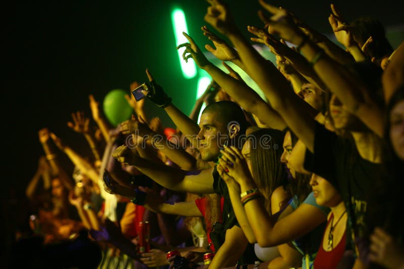 Belgrade, Serbia - August 19, 2011: Happy crowd raises his hands to the favorite song. Beer Fest is the most visited free festival in Serbia, where during the five days, beer drinkers can enjoy a variety of beers and music. Belgrade, Serbia - August 19, 2011: Happy crowd raises his hands to the favorite song. Beer Fest is the most visited free festival in Serbia, where during the five days, beer drinkers can enjoy a variety of beers and music