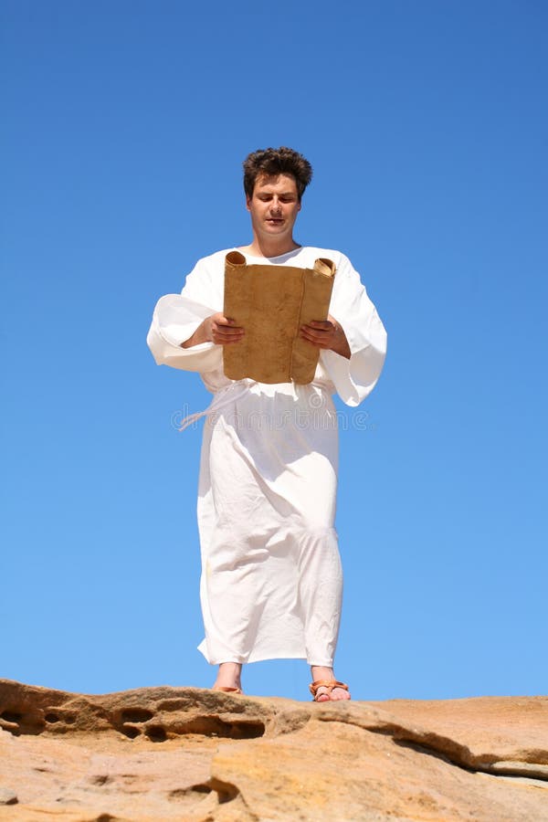 Ancient man in white robe reading from parchment scroll. Ancient man in white robe reading from parchment scroll