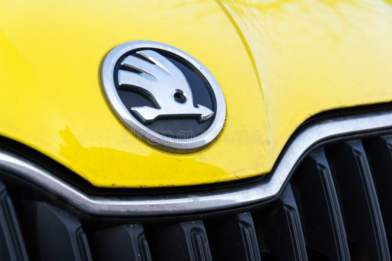 PRAGUE, CZECH REPUBLIC - MARCH 25 2018: Skoda Auto automobile manufacturer from Volkswagen Group company logo on yellow dirty car on March 25, 2018 in Prague, Czech Republic. PRAGUE, CZECH REPUBLIC - MARCH 25 2018: Skoda Auto automobile manufacturer from Volkswagen Group company logo on yellow dirty car on March 25, 2018 in Prague, Czech Republic.