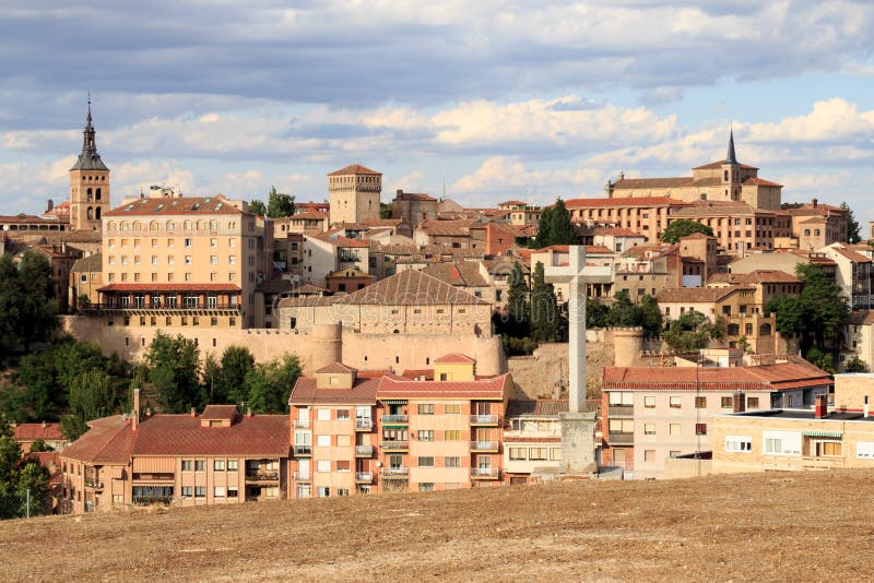 City of Segovia, seen from the mirador de la Piedad with her stone crosses. On the left the tower of the Iglesia Anglicana. In the front the walls of Segovia Spanish: Murallas de Segovia. They are the remains of the medieval city walls surrounding Segovia in Castile and León. City of Segovia, seen from the mirador de la Piedad with her stone crosses. On the left the tower of the Iglesia Anglicana. In the front the walls of Segovia Spanish: Murallas de Segovia. They are the remains of the medieval city walls surrounding Segovia in Castile and León.