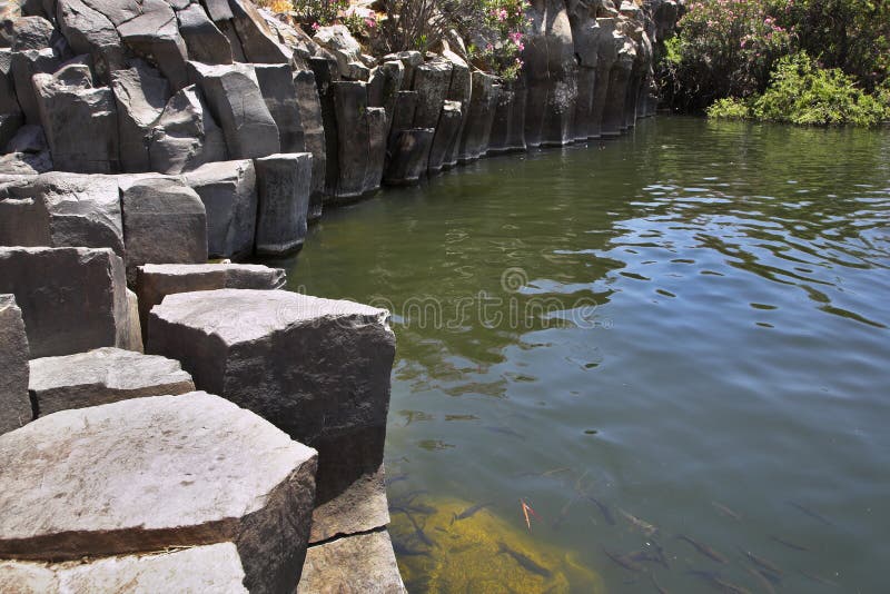 Drying up stream between picturesque stone polyhedrons in mountains of Israel. Drying up stream between picturesque stone polyhedrons in mountains of Israel