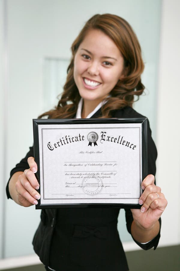 A business woman holding a certificate (focus on certificate). A business woman holding a certificate (focus on certificate)