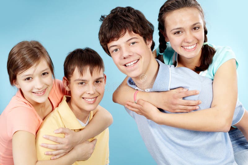 Portrait of two teenage couples looking at camera and smiling. Portrait of two teenage couples looking at camera and smiling