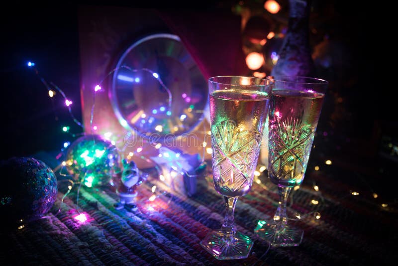 Two glasses of champagne with Christmas decoration. Traditional winter holiday alcohol drink in snow with creative New Year artwork. Copy space. Selective focus. Two glasses of champagne with Christmas decoration. Traditional winter holiday alcohol drink in snow with creative New Year artwork. Copy space. Selective focus