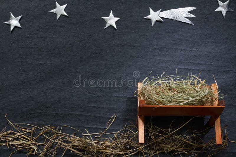 Manger and star of Bethlehem abstracy christmas background nativity scene on black marble closeup. Manger and star of Bethlehem abstracy christmas background nativity scene on black marble closeup