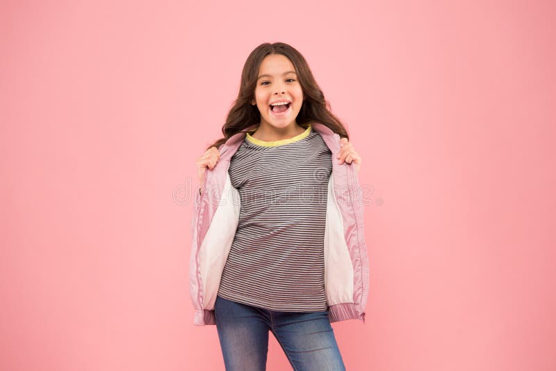 Hey you. Keeping active in fall. You need it for autumn. Happy child show handguns pink background. Little girl with autumn look. Casual autumn style. Fashion autumn outfit. Fashion trends for kids. Hey you. Keeping active in fall. You need it for autumn. Happy child show handguns pink background. Little girl with autumn look. Casual autumn style. Fashion autumn outfit. Fashion trends for kids.