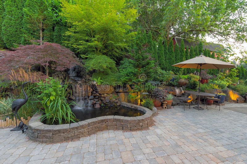 Backyard Garden landscaping with waterfall pond trees plants trellis decor furniture brick pavers patio hardscape. Backyard Garden landscaping with waterfall pond trees plants trellis decor furniture brick pavers patio hardscape