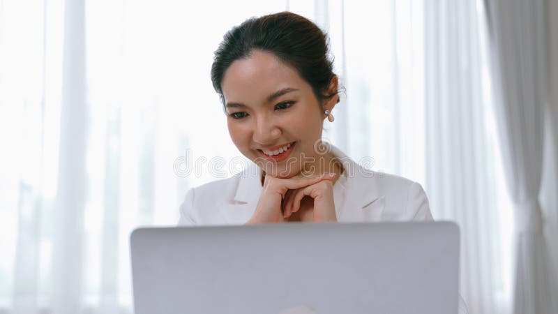 Young businesswoman sitting on the workspace desk using laptop computer for internet online content writing or secretary remote working from home. Vivancy. Young businesswoman sitting on the workspace desk using laptop computer for internet online content writing or secretary remote working from home. Vivancy