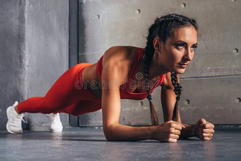 Side view of fit woman doing plank core exercise. Side view of fit woman doing plank core exercise