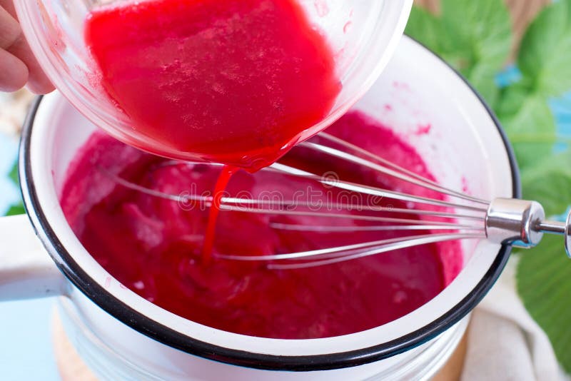 Making Raspberry Sauce on a wooden table. Making Raspberry Sauce on a wooden table