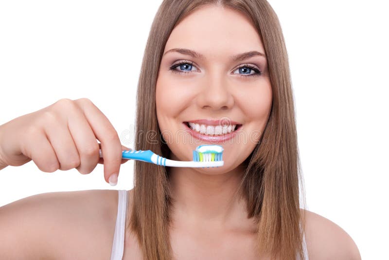 Young woman smiling with healthy teeth and a tooth-brush, isolated on white. Young woman smiling with healthy teeth and a tooth-brush, isolated on white