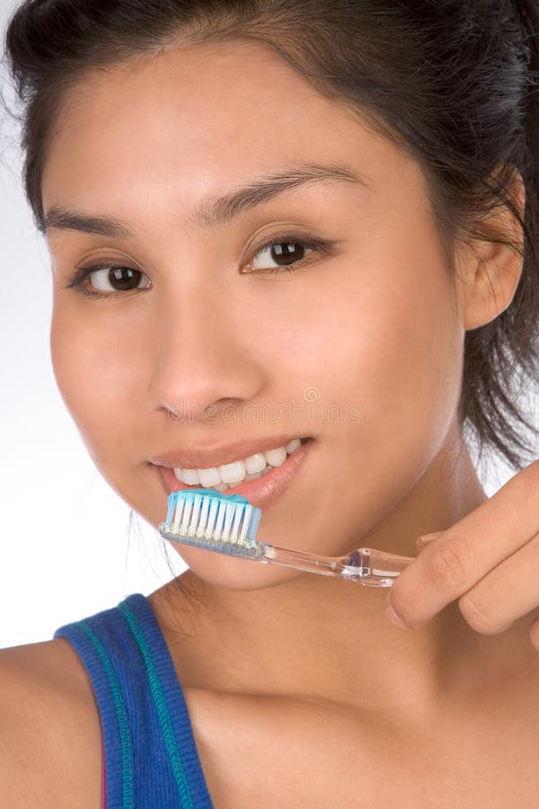 Latina teenager girl brushes her teeth, it's important for teens as well as for adult to brush. Latina teenager girl brushes her teeth, it's important for teens as well as for adult to brush