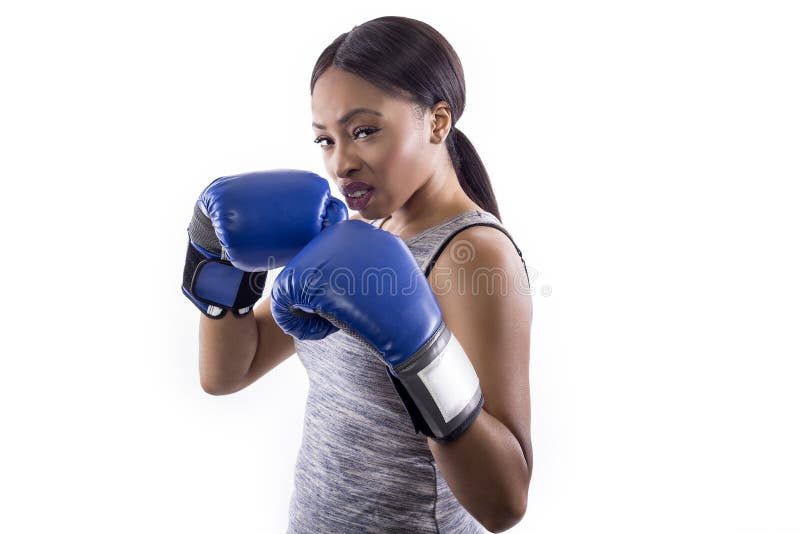 Black female on a white background wearing boxing gloves looking confident and smug. Part of image set for gritty woman series. Black female on a white background wearing boxing gloves looking confident and smug. Part of image set for gritty woman series.