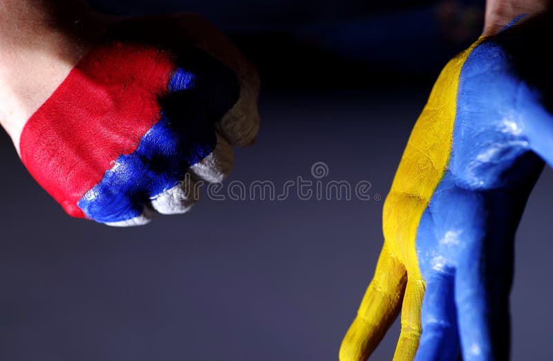 Children`s hands are painted color of a flag of Ukraine and Russia.Ukraine and Russia.War with Russia. Children`s hands are painted color of a flag of Ukraine and Russia.Ukraine and Russia.War with Russia.