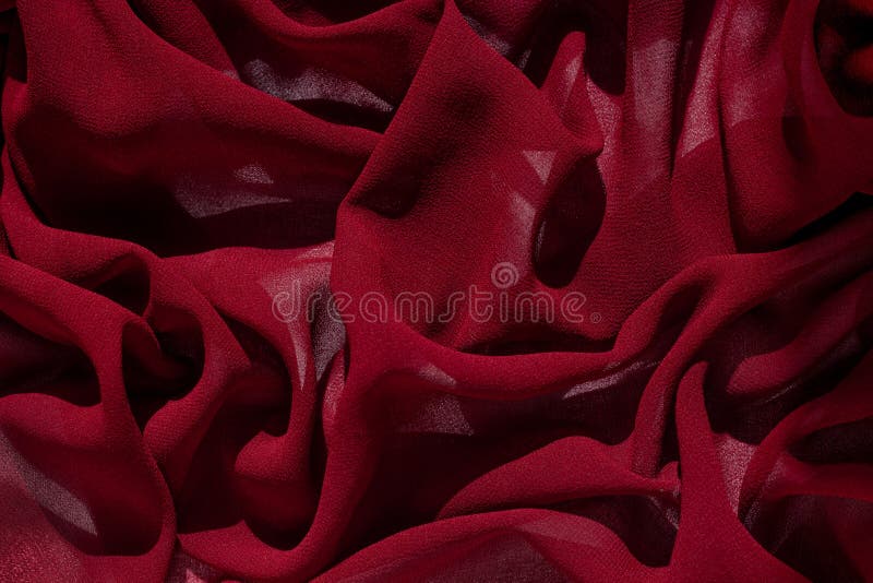 Smooth elegant burgundy chiffon fabric abstract background. Dark red wine silk satin luxury cloth texture on light surface for design. Luxurious Valentine`s day backdrop. Wavy matte textured material. Smooth elegant burgundy chiffon fabric abstract background. Dark red wine silk satin luxury cloth texture on light surface for design. Luxurious Valentine`s day backdrop. Wavy matte textured material