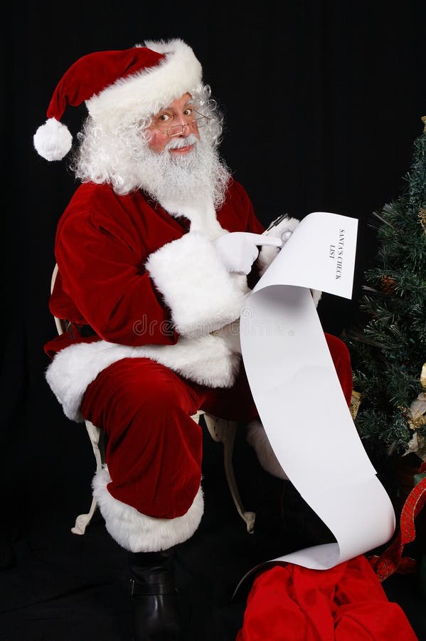 Santa Claus checking his naughty and nice list. Santa Claus checking his naughty and nice list