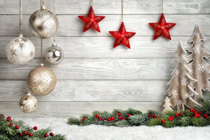 Christmas background in bright wood style, modern, simple and elegant, with a border of baubles, fir branches, stars, ornamental trees and snow. Christmas background in bright wood style, modern, simple and elegant, with a border of baubles, fir branches, stars, ornamental trees and snow