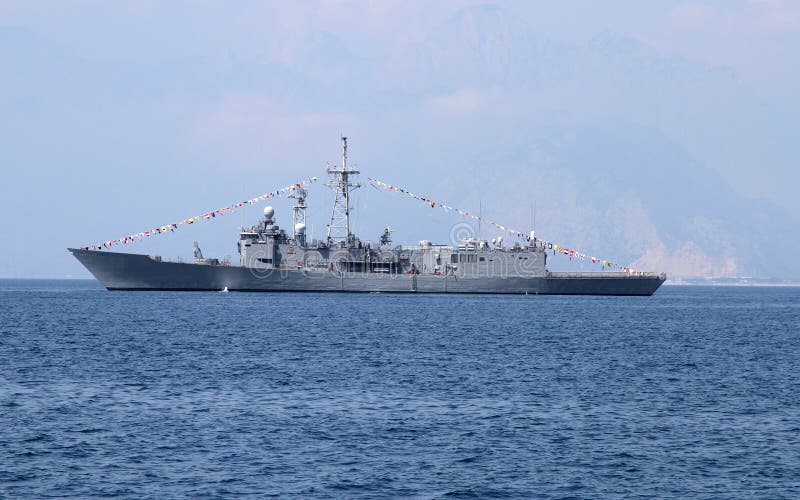 A grey navy warship anchored at sea. A grey navy warship anchored at sea