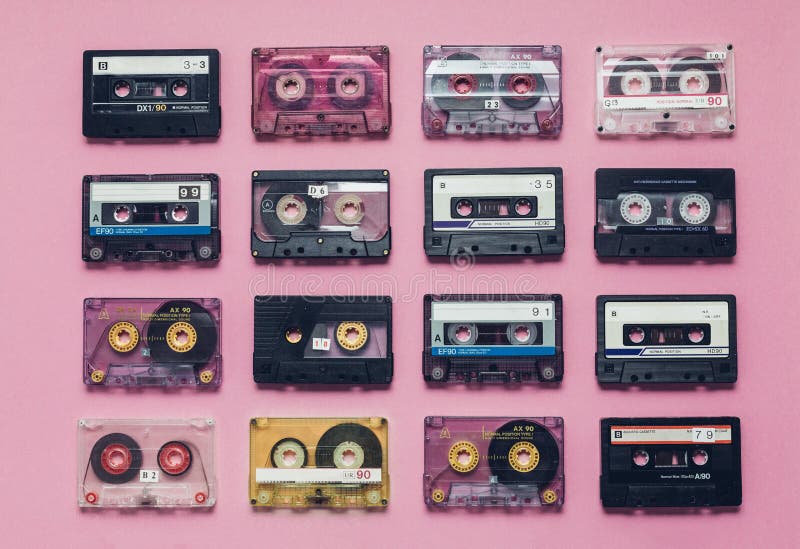 Collection Of Retro Audio Tapes In Row On Lilac Background. Retro Technology Music Concept. Collection Of Retro Audio Tapes In Row On Lilac Background. Retro Technology Music Concept