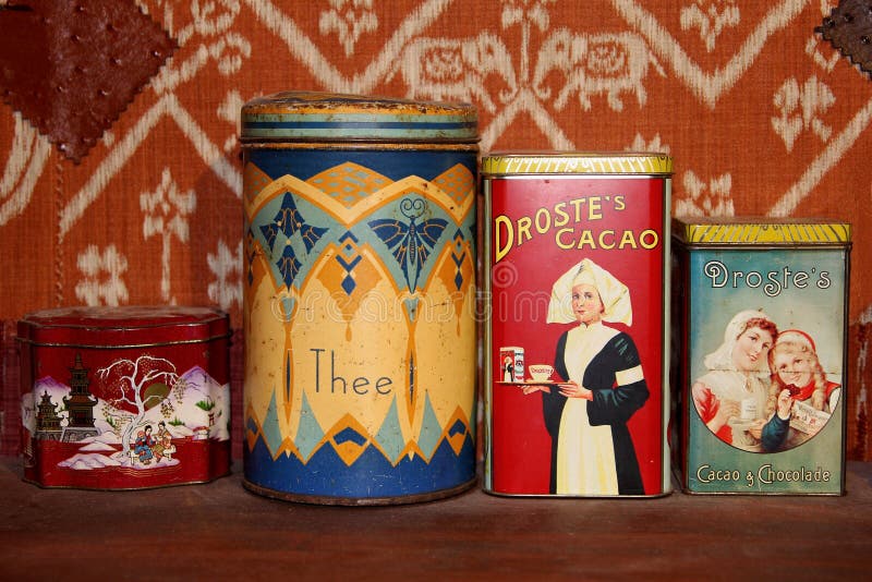 Retro antique tins with tea and Droste cacao and chocolate, made in the factory in Haarlem, Netherlands. Collectors items. Vintage. Brocante. Back tot the fifties and sixties. Nostalgia. The cacao powder can be used to prepare hot chocolate milk. Retro antique tins with tea and Droste cacao and chocolate, made in the factory in Haarlem, Netherlands. Collectors items. Vintage. Brocante. Back tot the fifties and sixties. Nostalgia. The cacao powder can be used to prepare hot chocolate milk