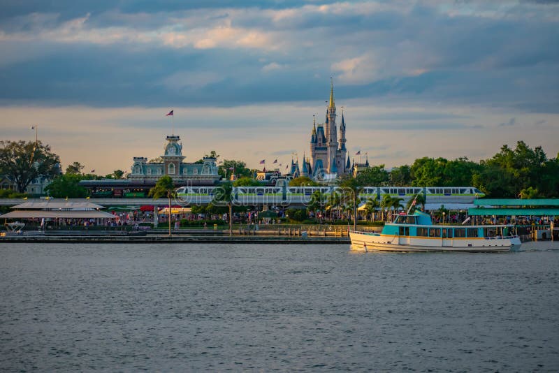 Orlando, Florida. April 02, 2019. Taxi boat, Monorail and panoramic view of Cinderella`s Castle and vintage Train Station at Magic Kingdom in Walt Disney World. Orlando, Florida. April 02, 2019. Taxi boat, Monorail and panoramic view of Cinderella`s Castle and vintage Train Station at Magic Kingdom in Walt Disney World