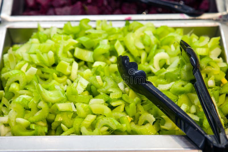 Sliced celery in a pan on a stand in a food market. Sliced celery in a pan on a stand in a food market