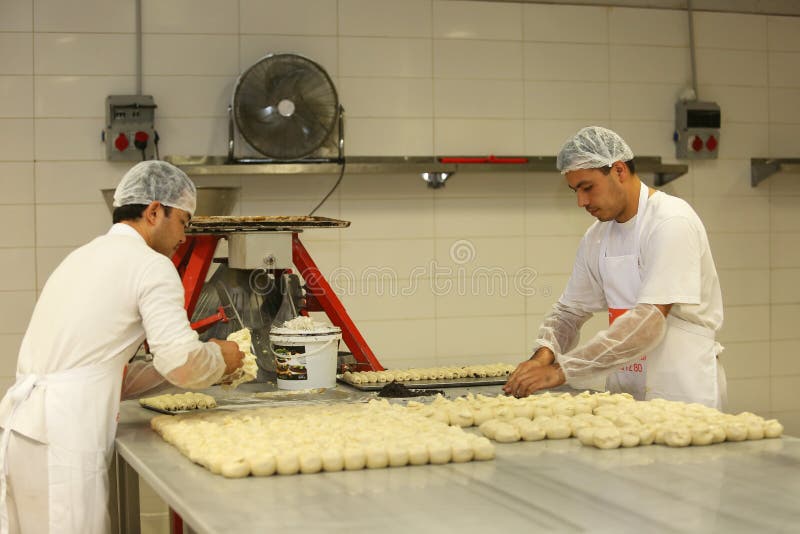 ISTANBUL, TURKEY - AUGUST 10: Turkish chefs making unbaked cookies in the baker factory on August 10, 2017 in Istanbul, Turkey. ISTANBUL, TURKEY - AUGUST 10: Turkish chefs making unbaked cookies in the baker factory on August 10, 2017 in Istanbul, Turkey.