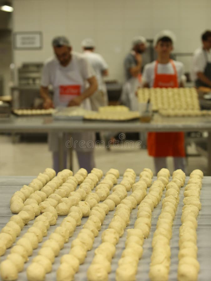 ISTANBUL, TURKEY - AUGUST 10: Turkish chefs making unbaked cookies in the baker factory on August 10, 2017 in Istanbul, Turkey. ISTANBUL, TURKEY - AUGUST 10: Turkish chefs making unbaked cookies in the baker factory on August 10, 2017 in Istanbul, Turkey.