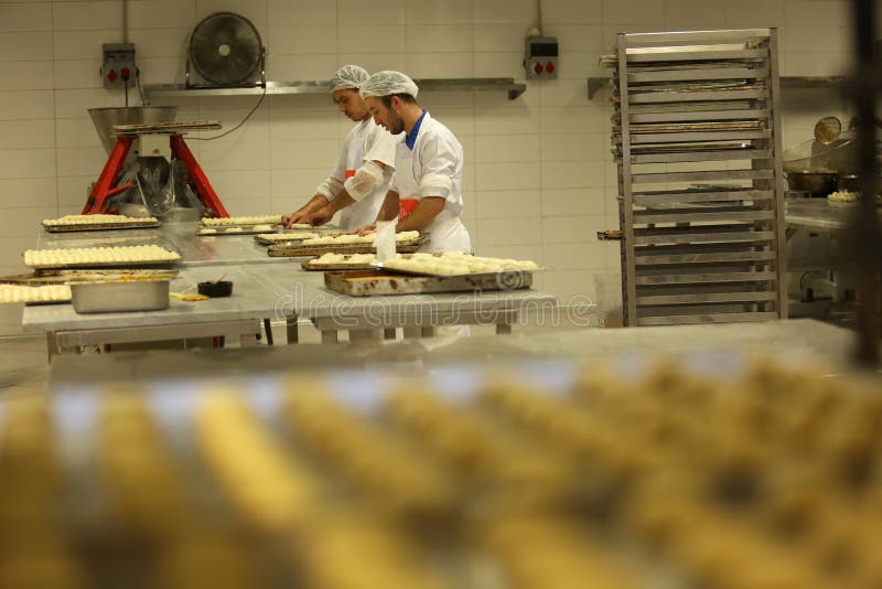 ISTANBUL, TURKEY - AUGUST 10: Turkish chefs making unbaked foods in the baker factory on August 10, 2017 in Istanbul, Turkey. ISTANBUL, TURKEY - AUGUST 10: Turkish chefs making unbaked foods in the baker factory on August 10, 2017 in Istanbul, Turkey.