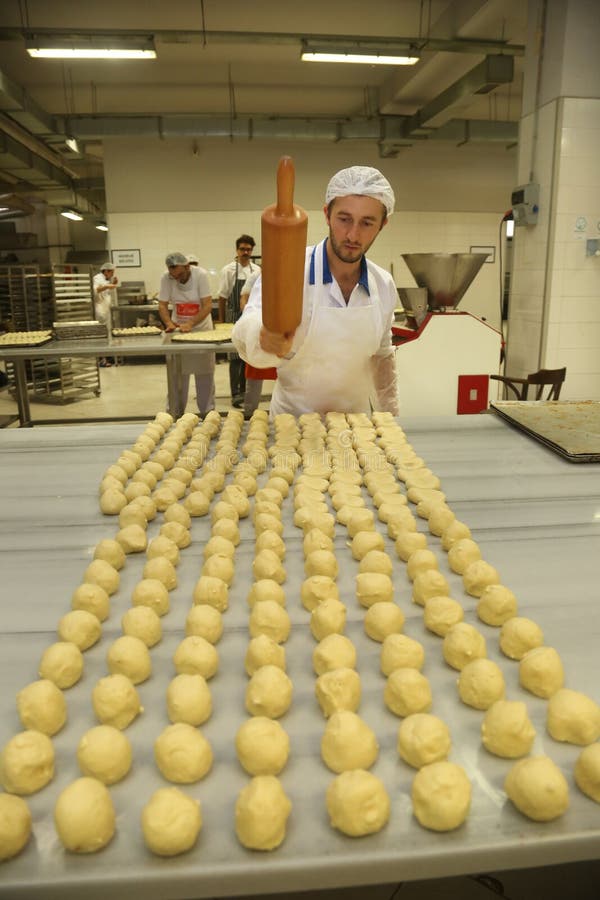 ISTANBUL, TURKEY - AUGUST 10: Turkish chef making unbaked cookies in the baker factory on August 10, 2017 in Istanbul, Turkey. ISTANBUL, TURKEY - AUGUST 10: Turkish chef making unbaked cookies in the baker factory on August 10, 2017 in Istanbul, Turkey.