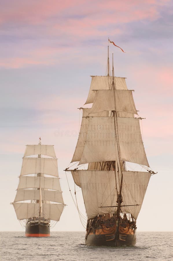 Tall wooden vintage sailing ships shot on the high seas from the front. Tall wooden vintage sailing ships shot on the high seas from the front