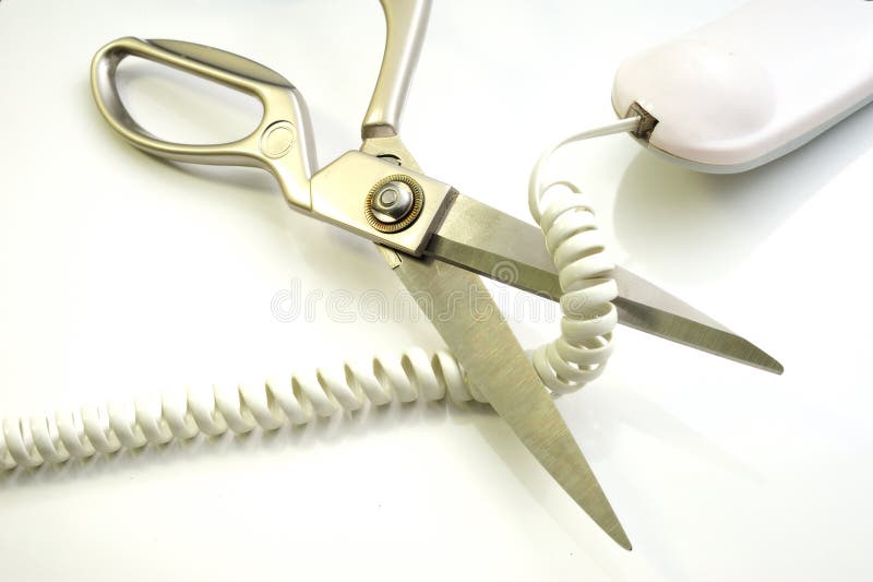 Telephone cord being cut by scissors (communication concept). Telephone cord being cut by scissors (communication concept)