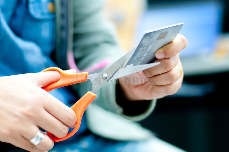 Woman cutting credit card for finance problem concept. Woman cutting credit card for finance problem concept