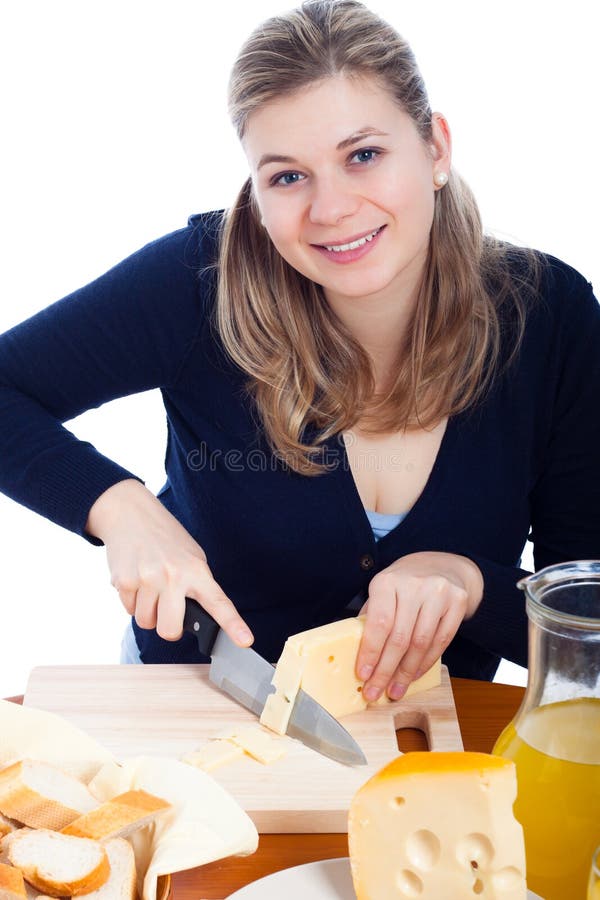 Beautiful young happy woman cutting emmenthal cheese, isolated on white background. Beautiful young happy woman cutting emmenthal cheese, isolated on white background.