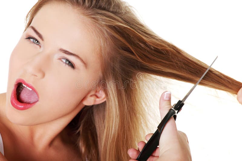 Mad teen woman going to cut her hair with scissors. Mad teen woman going to cut her hair with scissors