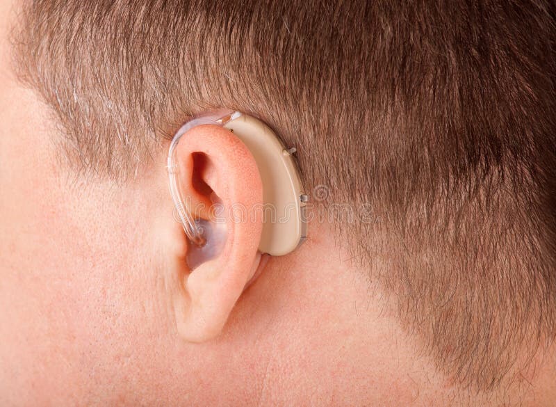 Close up of a man's ear with hearing aid. Close up of a man's ear with hearing aid