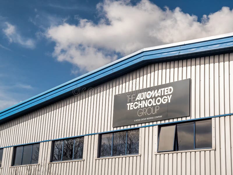 Northampton UK March 16 2018: The Automated Technology Group A Wood Group Mustang Company logo banner on warehouse wall in Moulton Industrial Estate. Northampton UK March 16 2018: The Automated Technology Group A Wood Group Mustang Company logo banner on warehouse wall in Moulton Industrial Estate.