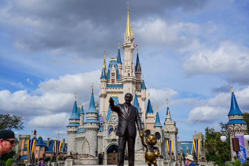 Orlando, FL/USA - 02/07/18: Walt Disney and Mickey Mouse Partners statue in front of Cinderellas Castle at Disney World`s Magic Kingdom. Orlando, FL/USA - 02/07/18: Walt Disney and Mickey Mouse Partners statue in front of Cinderellas Castle at Disney World`s Magic Kingdom