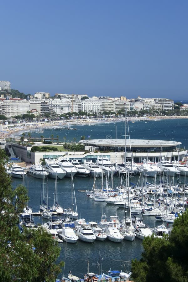 Blue skies over yachts in cannes marina on the French Riviera and promenade lined with hotels. Blue skies over yachts in cannes marina on the French Riviera and promenade lined with hotels