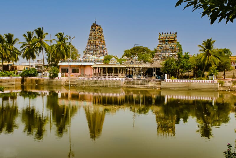 This Hindu Temple, commonly referred to as the Pillaiyarpatti Temple, is dedicated to the Deity, Lord Ganesha, or Lord of Wisdom. The stone idol is carved out from a rock in a cave, on the hillock of Pillaiyarpatti. Temple was built during the reign of the Pandya kings and dates to between 1091 and 1238 AD, according to stone inscriptions found. 
In the cave temple, there are also rock cut images of Lord Shiva and other Gods. The age of the cave temple is 2500 years or more. There are 14 stone Sculptures in the cave dating from 500 BC to 1284 AD
Photo shows the Temple complex, with the reflection of the Temple Towers and adjacent trees in the still waters of the tank. Shot on July 10, 2011, at 01.15 PM, with a Canon DSLR EOS 300D. This Hindu Temple, commonly referred to as the Pillaiyarpatti Temple, is dedicated to the Deity, Lord Ganesha, or Lord of Wisdom. The stone idol is carved out from a rock in a cave, on the hillock of Pillaiyarpatti. Temple was built during the reign of the Pandya kings and dates to between 1091 and 1238 AD, according to stone inscriptions found. 
In the cave temple, there are also rock cut images of Lord Shiva and other Gods. The age of the cave temple is 2500 years or more. There are 14 stone Sculptures in the cave dating from 500 BC to 1284 AD
Photo shows the Temple complex, with the reflection of the Temple Towers and adjacent trees in the still waters of the tank. Shot on July 10, 2011, at 01.15 PM, with a Canon DSLR EOS 300D.