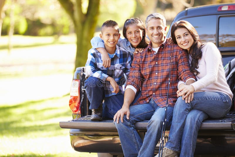 Happy Family Sitting In Pick Up Truck On Camping Holiday Smiling. Happy Family Sitting In Pick Up Truck On Camping Holiday Smiling