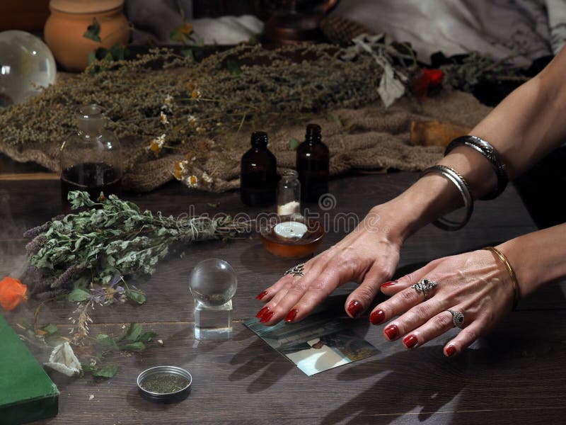 双手. 透明球. 炼金术师的魔术用具. 蜡烛. 概念替代医学 免版税库存图片