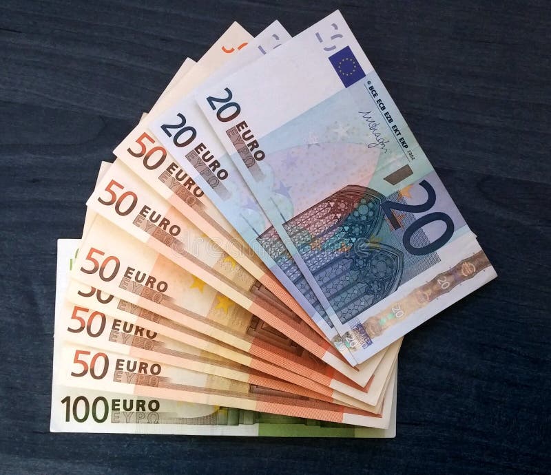 Euro bills of different values starting from 20 to 100. Banknotes on wooden background. Euro bills of different values starting from 20 to 100. Banknotes on wooden background.