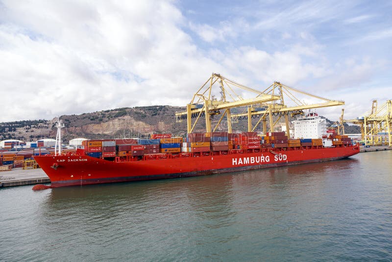 Barcelona, Spain - September 26, 2015: A container ships are standing in Barcelona port. It is Catalonia's largest port with a trade volume of 2.57 million TEU's. Barcelona, Spain - September 26, 2015: A container ships are standing in Barcelona port. It is Catalonia's largest port with a trade volume of 2.57 million TEU's.