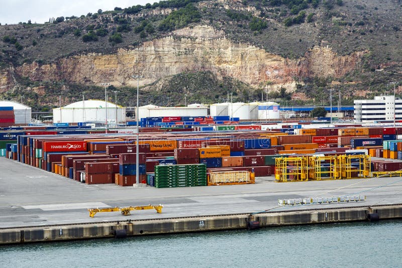 Barcelona, Spain - September 26, 2015: A container ships are standing in Barcelona port. It is Catalonia's largest port with a trade volume of 2.57 million TEU's. Barcelona, Spain - September 26, 2015: A container ships are standing in Barcelona port. It is Catalonia's largest port with a trade volume of 2.57 million TEU's.