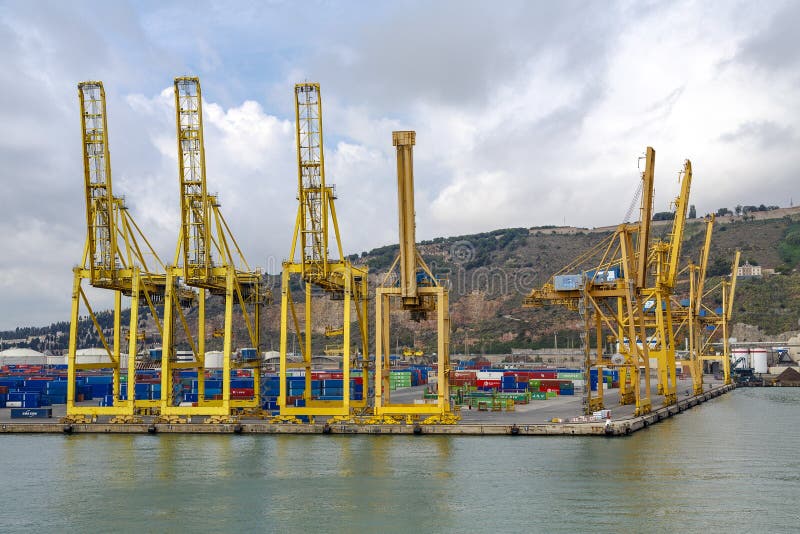 Barcelona, Spain - September 26, 2015: A container ships are standing in Barcelona port. It is Catalonia's largest port with a trade volume of 2.57 million TEU's. Barcelona, Spain - September 26, 2015: A container ships are standing in Barcelona port. It is Catalonia's largest port with a trade volume of 2.57 million TEU's.