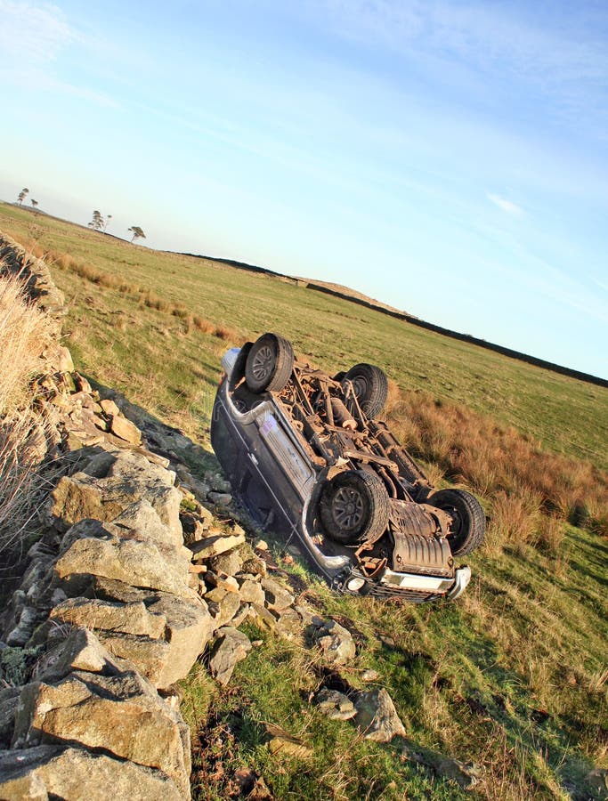 The morning after the night before. A four wheeled drive vehicle lies overturned after failing to take a bend and crashing through Stone wall, Police sign to side of vehicle. The morning after the night before. A four wheeled drive vehicle lies overturned after failing to take a bend and crashing through Stone wall, Police sign to side of vehicle